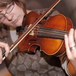 Woman plays the violin for home music